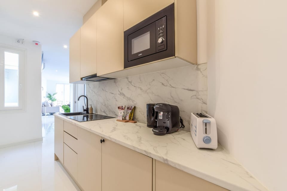 Main view of the kitchen space with appliances