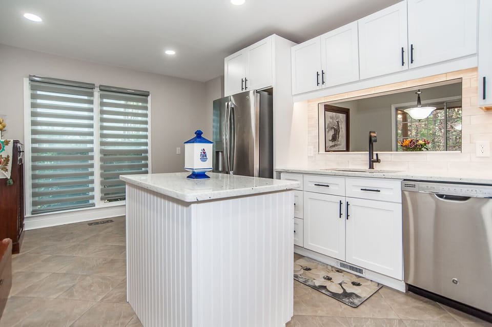 Fully furnished kitchen, island, frig, microwave, dishwasher, view dining area.