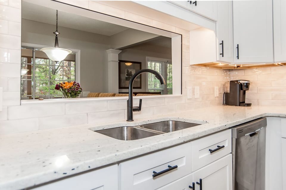 Kitchen area with nice view into dining area and screened porch.