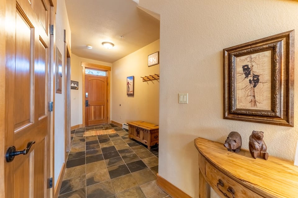 Entry hallway with bench, hooks, closet and laundry.