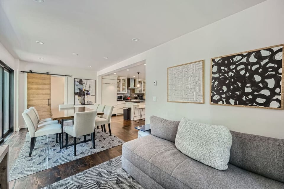 The dining room opens to a private backyard patio featuring a cozy gas fireplace, perfect for gatherings. Adjacent, a second living room adds extra comfort, seamlessly connecting to the kitchen for easy entertaining and family time.