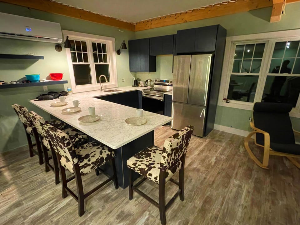 kitchen area, window by sink looks out at mountains and creek 