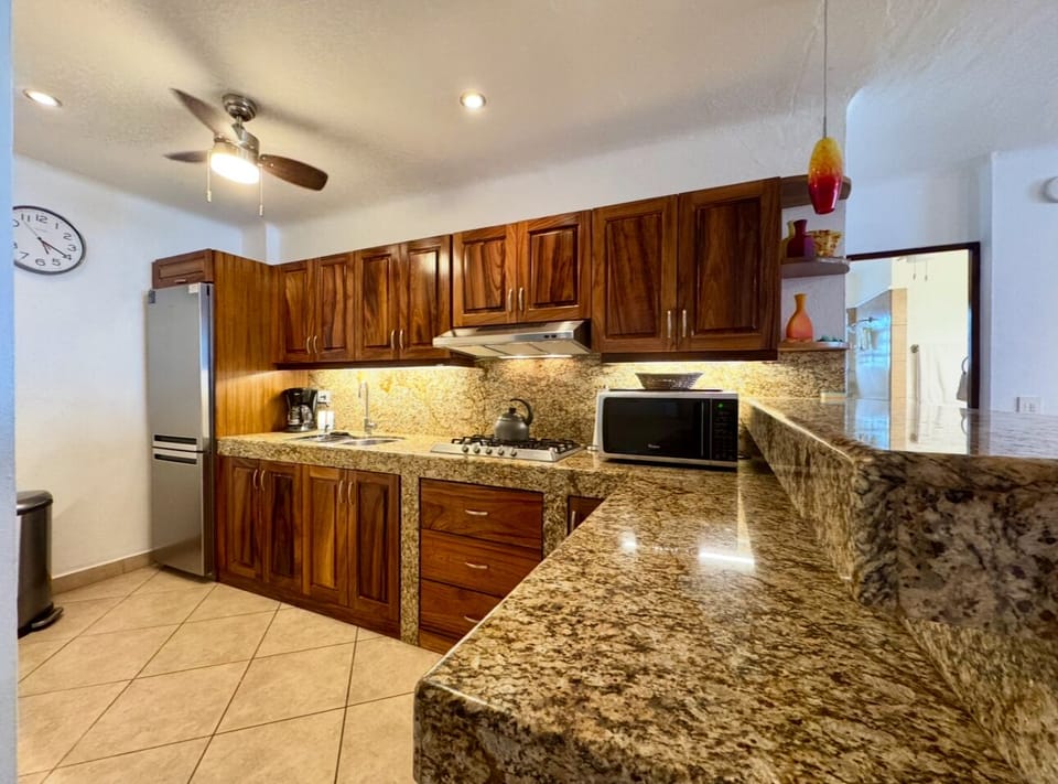 Kitchen has fridge/freezer, gas cooktop, microwave and coffee maker