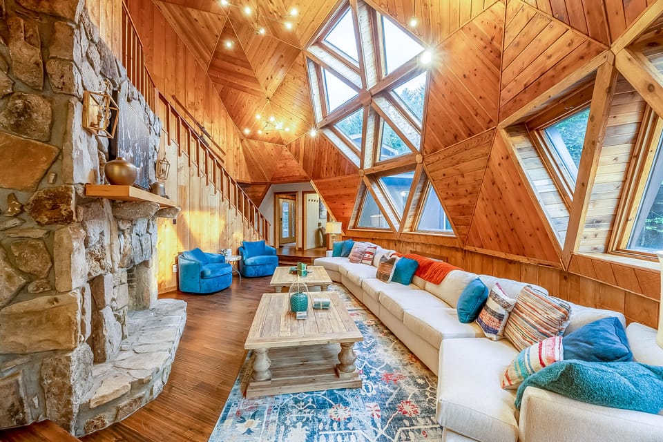 Relax and unwind in the open-concept living area, featuring soaring ceilings