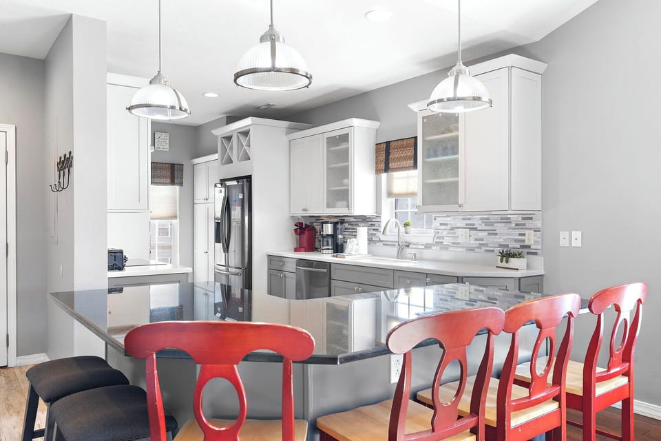 Fully equipped kitchen with upgraded appliances, wine cooler, and additional bar seating