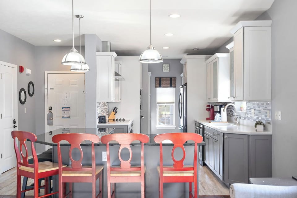 Fully equipped kitchen with upgraded appliances, wine cooler, and additional bar seating