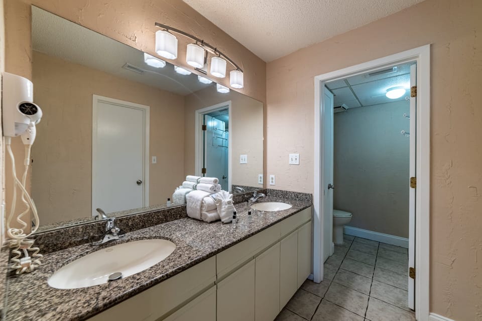 The Pond View Main bath is your en-suite private bathroom.  there is a large vanity area and a separate tub/toilet area.