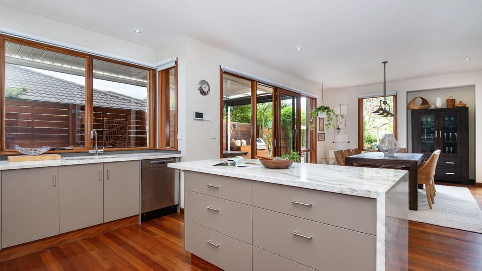 Kitchen - Island Bench looking out onto dining and deck