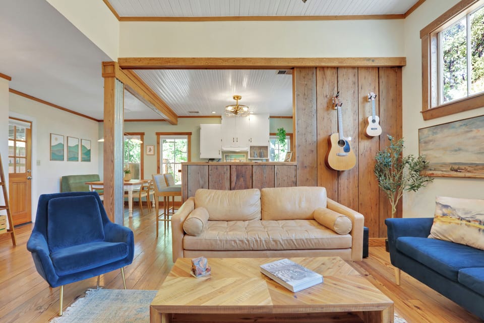 West Elm leather sofa with acoustic guitar and ukelele for guests to play