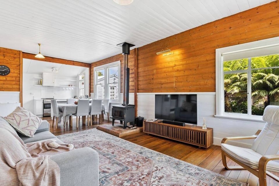 Experience relaxation in the spacious living room, featuring a cosy slow-combustion wood fireplace. 