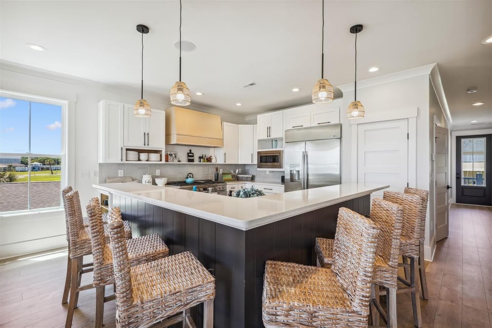 The kitchen island provides additional counter space for serving snacks or meals