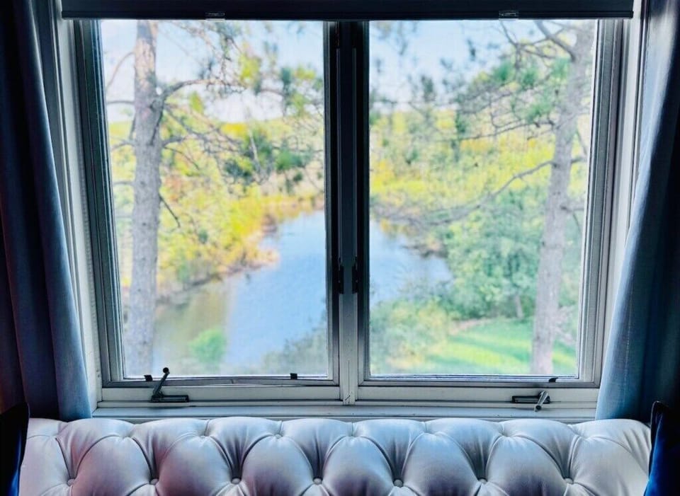 Bedroom 3: From sunrise to sunset, enjoy stunning views of our private pond for a true North Shore retreat!