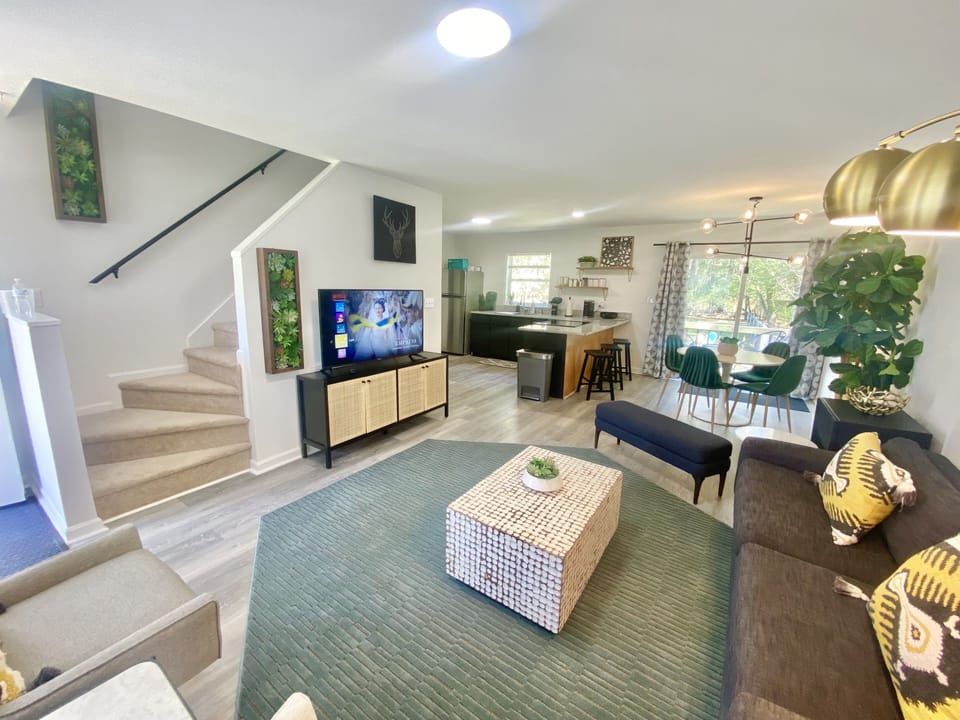 Open main floor living dinning area with 60 inch smart TV