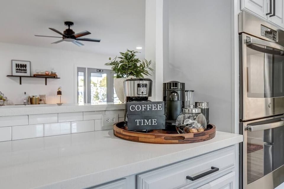 Modern kitchen counter with coffee station and stainless steel appliances