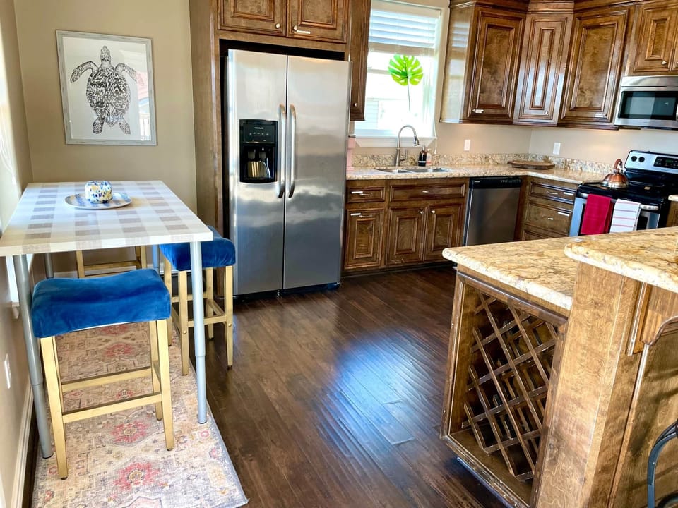 Kitchen is large, well-equipped, and very organized. New appliances & dishes too