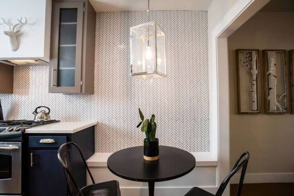 Cozy two person dining nook right off the kitchen, great for morning coffee or takeout nights.