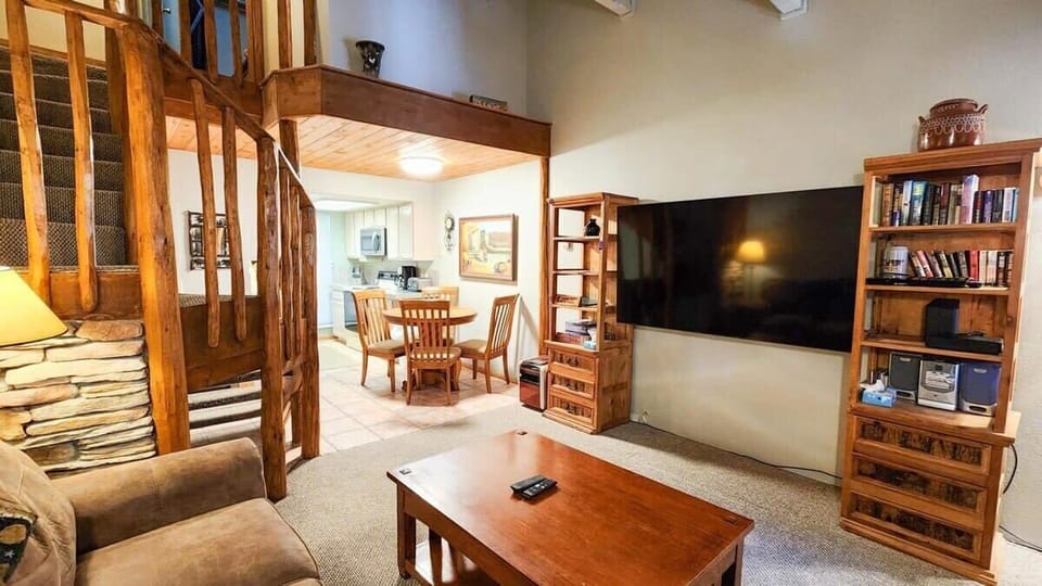 The view over the main living space showcases the open layout living, dining, and kitchen area making it easy to stay connected with your group while in the condo.