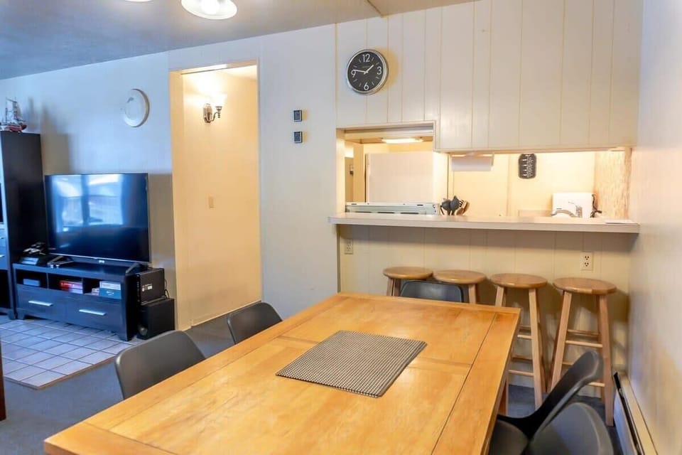 The view from the dining table to the pass-thru kitchen bar provides two dining options for your group to enjoy a meal.