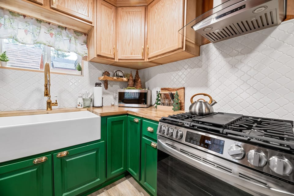 Cabinets are stocked with plates, bowls, glasses, coffee cups and wine glasses.