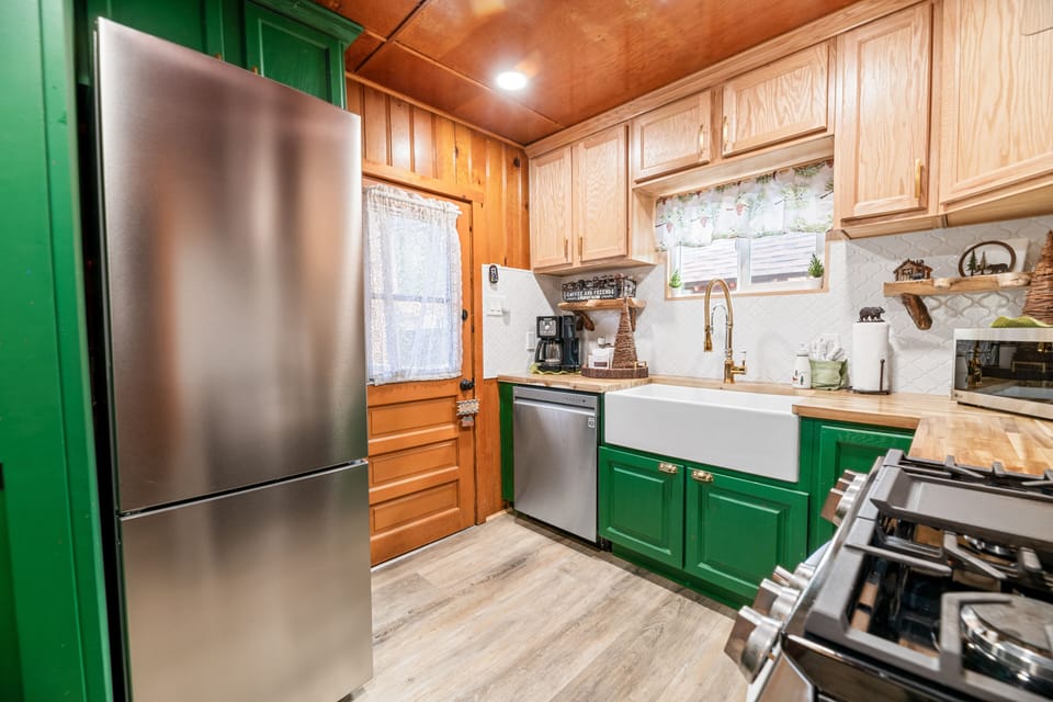 A fully equipped beautifully designed kitchen with wood countertops.