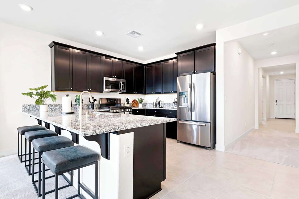 Cleanup's a breeze with the sleek stainless steel double sink and modern kitchen design. 