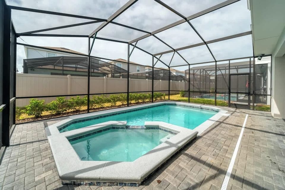 Screened-in pool invites refreshing swims and laid-back afternoons in a private setting.