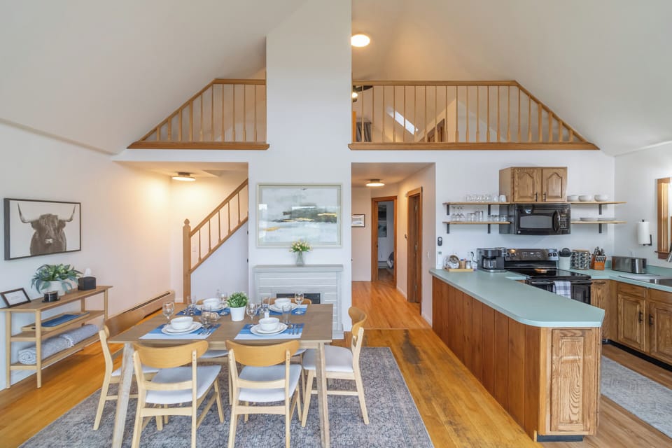 View of the dining room and kitchen with the loft upstairs