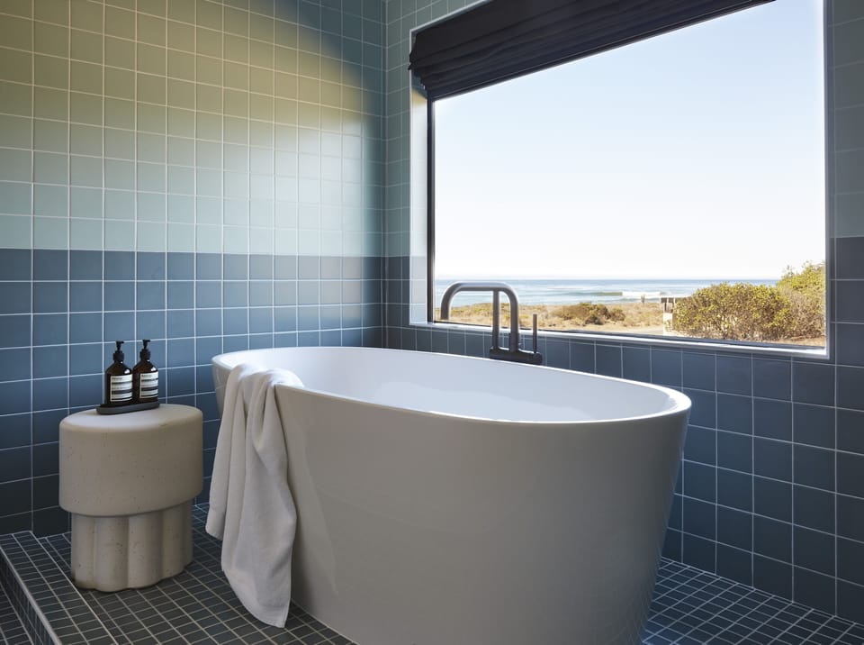 Shower, designer toiletries, hair dryer, slippers