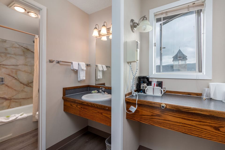 Economy Room, 2 Queen Beds, Non Smoking, No View | Bathroom | Combined shower/tub, free toiletries, hair dryer, towels