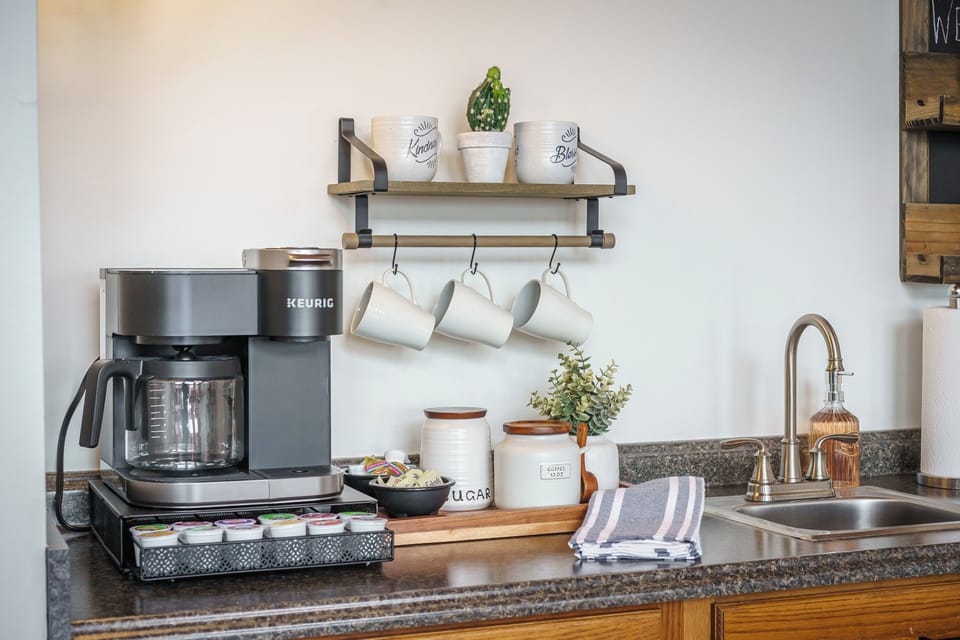 Upper level coffee bar with a combo Keurig & drip coffee, sink, and mini fridge