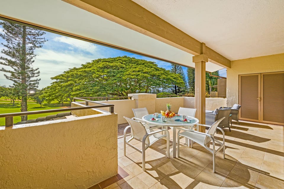 Spacious lanai with seating and dining area overlooking the Kapalua golf course—ideal for morning mimosas or evening cocktails in paradise.
