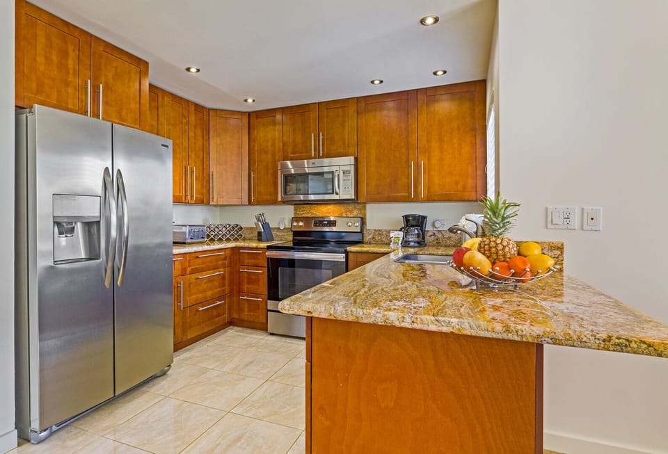 Fully equipped gourmet kitchen with granite countertops, stainless steel appliances, and everything you need for a Maui-style home-cooked meal.