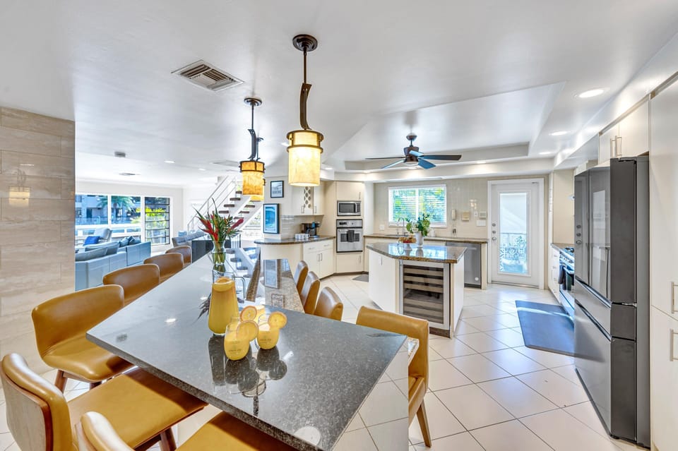 The large, eat in kitchen includes seating for eight, a professional gas stove and an oversized island.