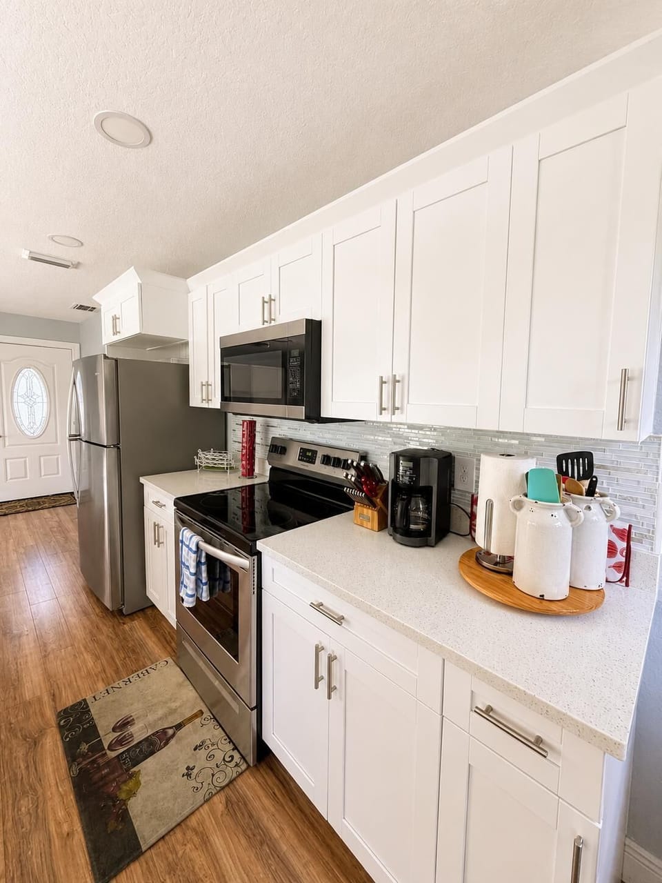 microwave, indoor, coffee and or coffee maker, kitchen, oven, refrigerator.