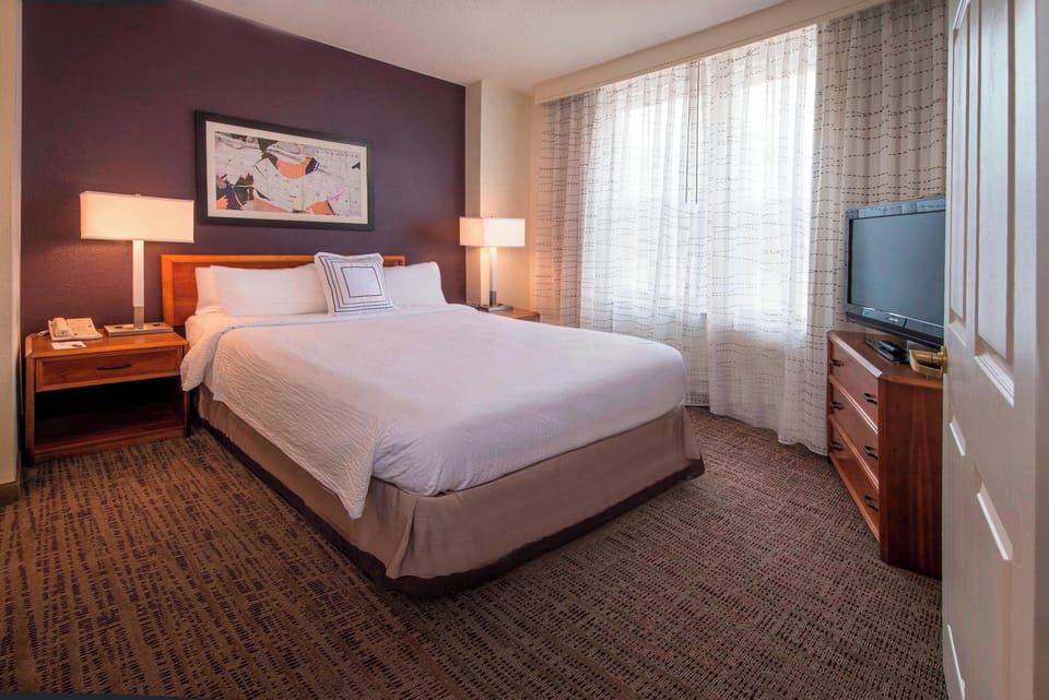 Premium bedding, desk, laptop workspace, blackout drapes