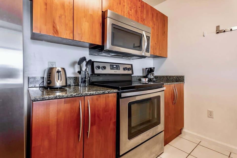 Fully equipped kitchen area with appliances and cookware
