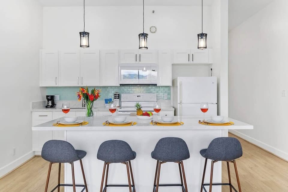Fully equipped kitchen with countertop dining area with 4 bar stools