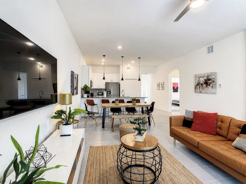 Bright Open Living Area with Leather Sofa and Dining Table