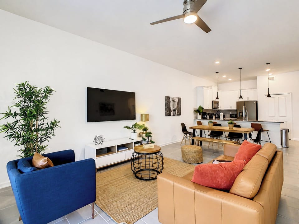 Spacious Open-Concept Living Room with Mounted TV and Dining Area
