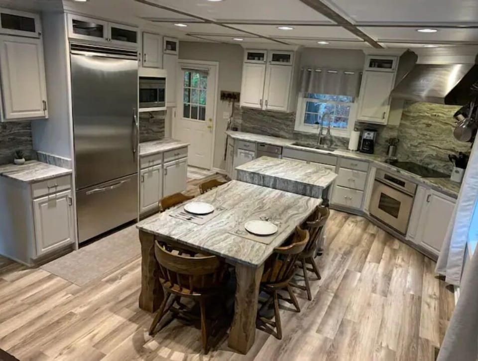 Gourmet Kitchen with textured granite countertops and stainless appliances