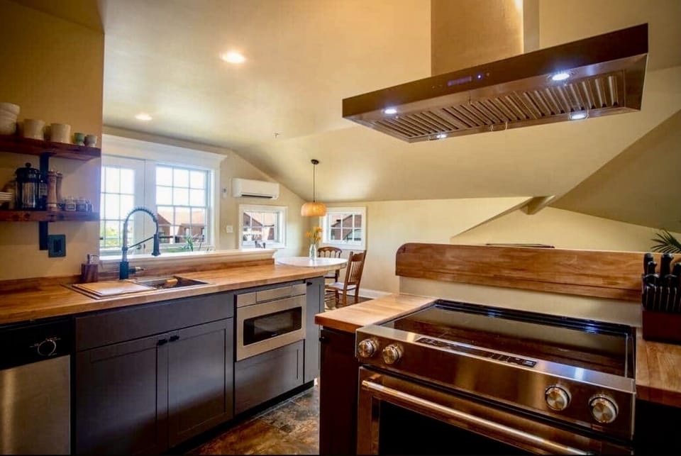 Kitchen with Dishwasher, Undercounter Microwave and Smoothtop Range is open to Dining-Living Area 