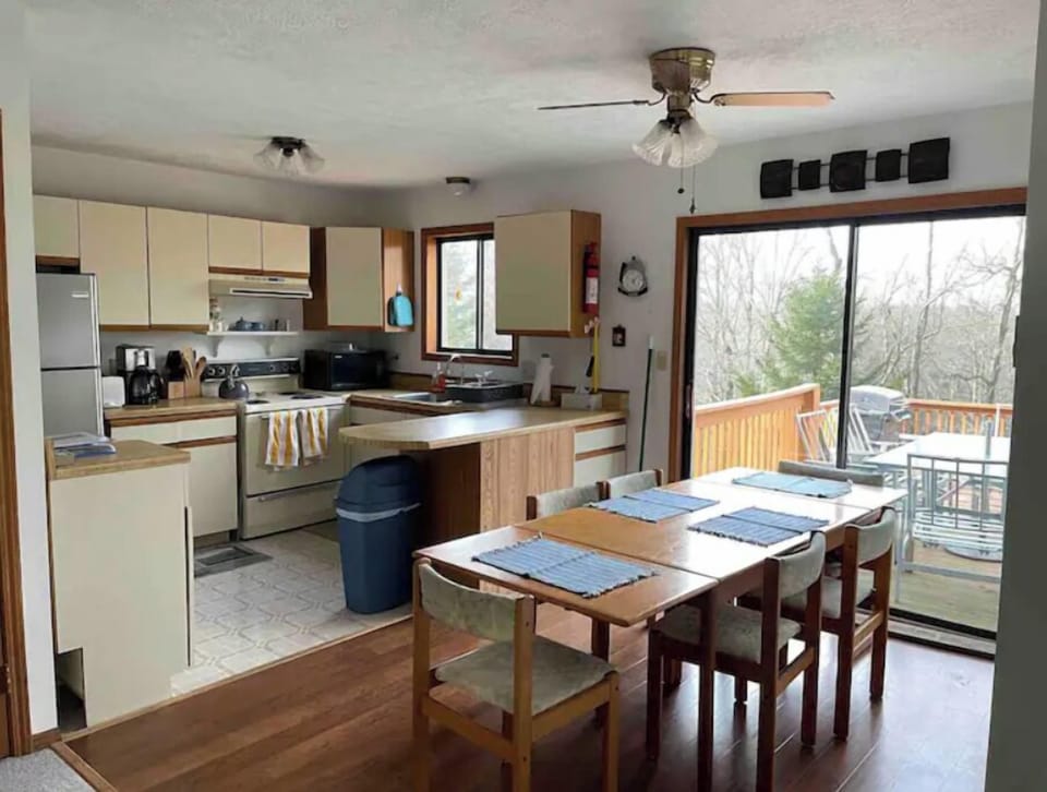 Kitchen and dining area with door to rear deck