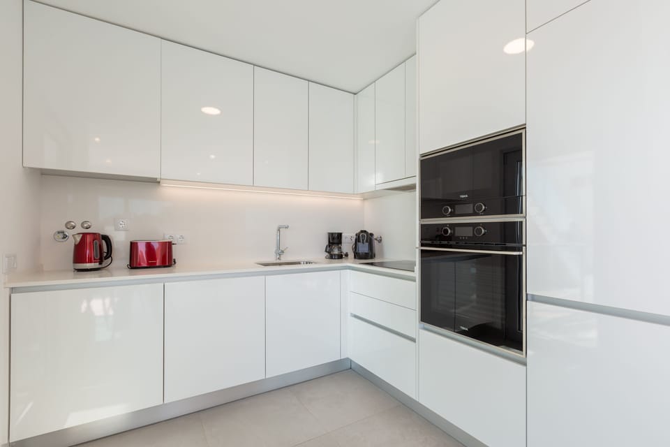 kitchen with washing machine and dishwasher, oven, micro-wave, fridge, freezer.