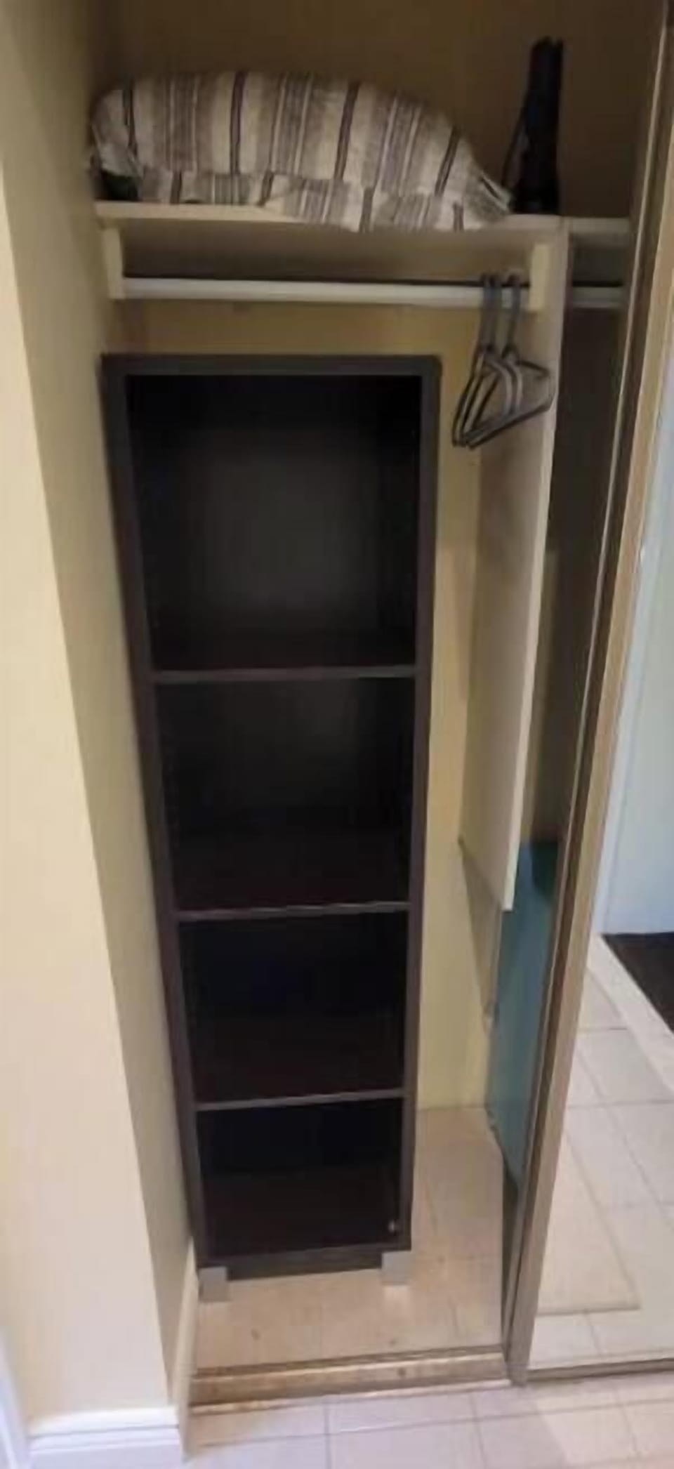 Ample shelving and hanging space for clothing and outerwear.