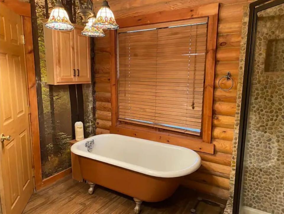 tub in master bedroom with bubble bath 
