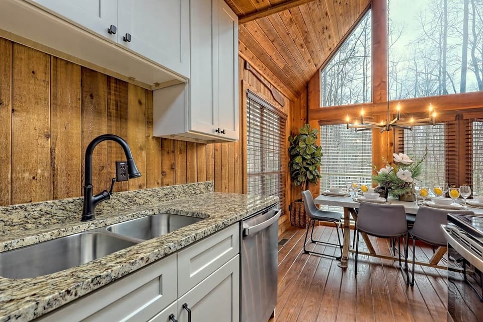 Modern open concept kitchen dining room, fully stocked w/ stainless appliances.