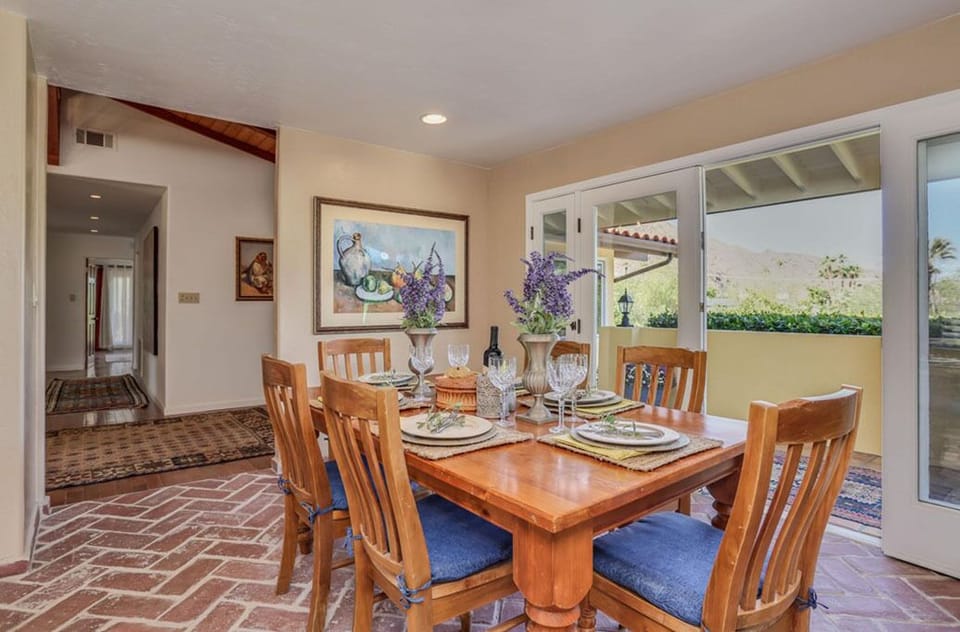 The dining room has large French doors opening up to the front terrace.