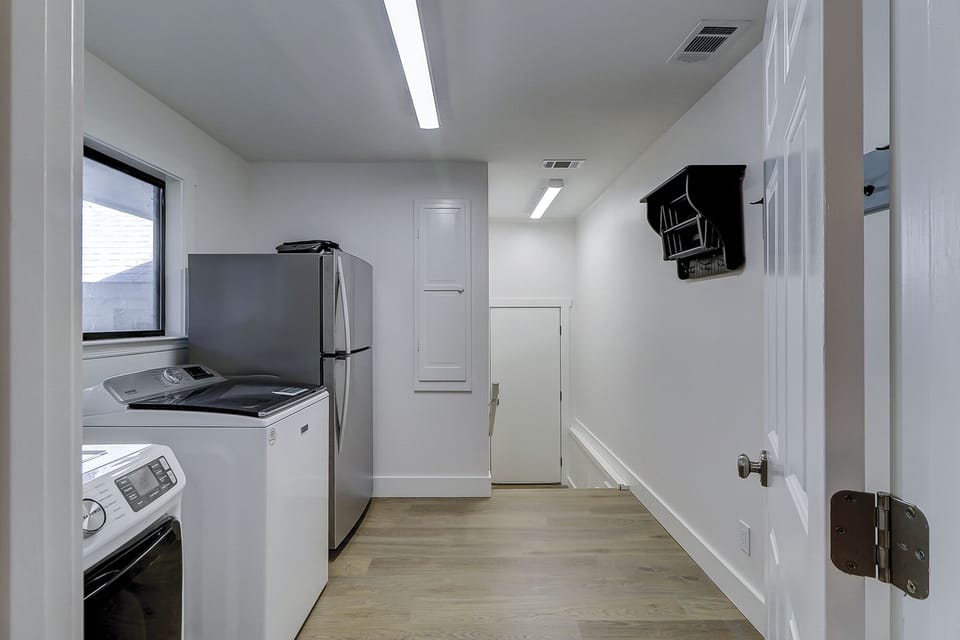 Full laundry room with new washer, dryer, and additional refrigerator