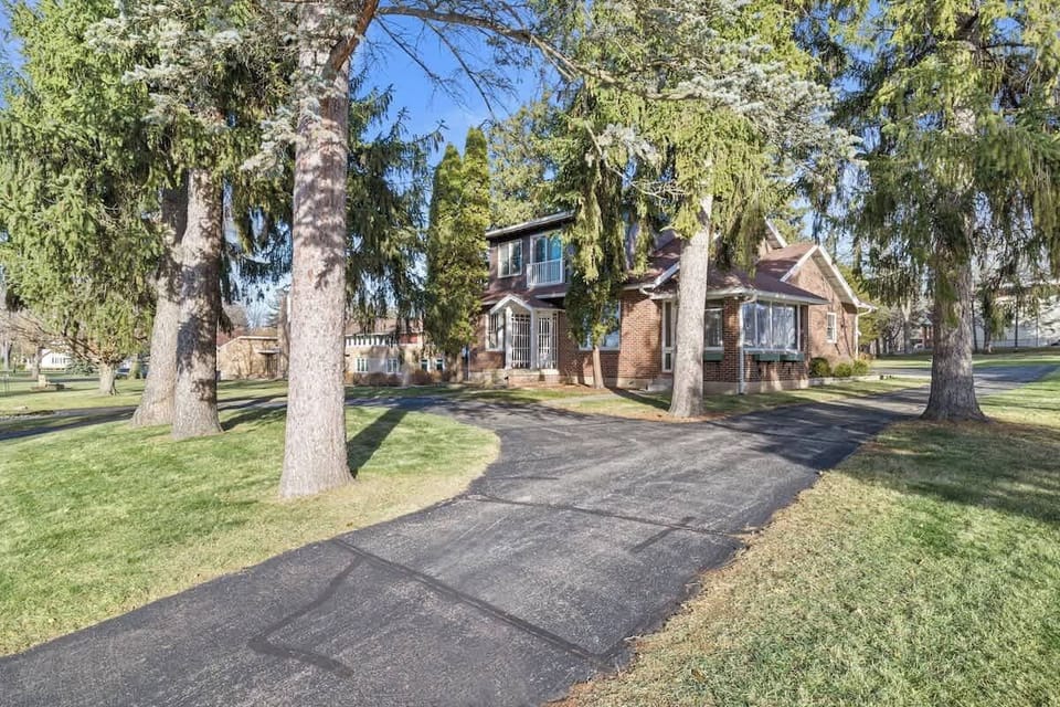 This spacious home is complete with the original red brick siding. The horseshoe driveway extends to the back of home for additional parking.