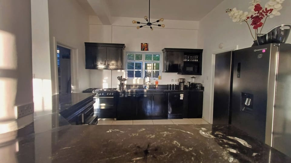 Our spacious kitchen with a double door fridge, cooker, oven, w/machine & coffee